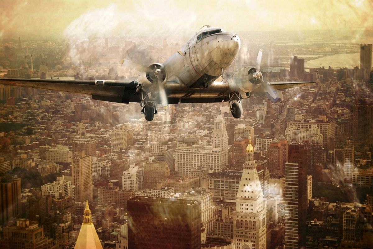 Papermoon Fototapete »Flugzeug über Stadt«