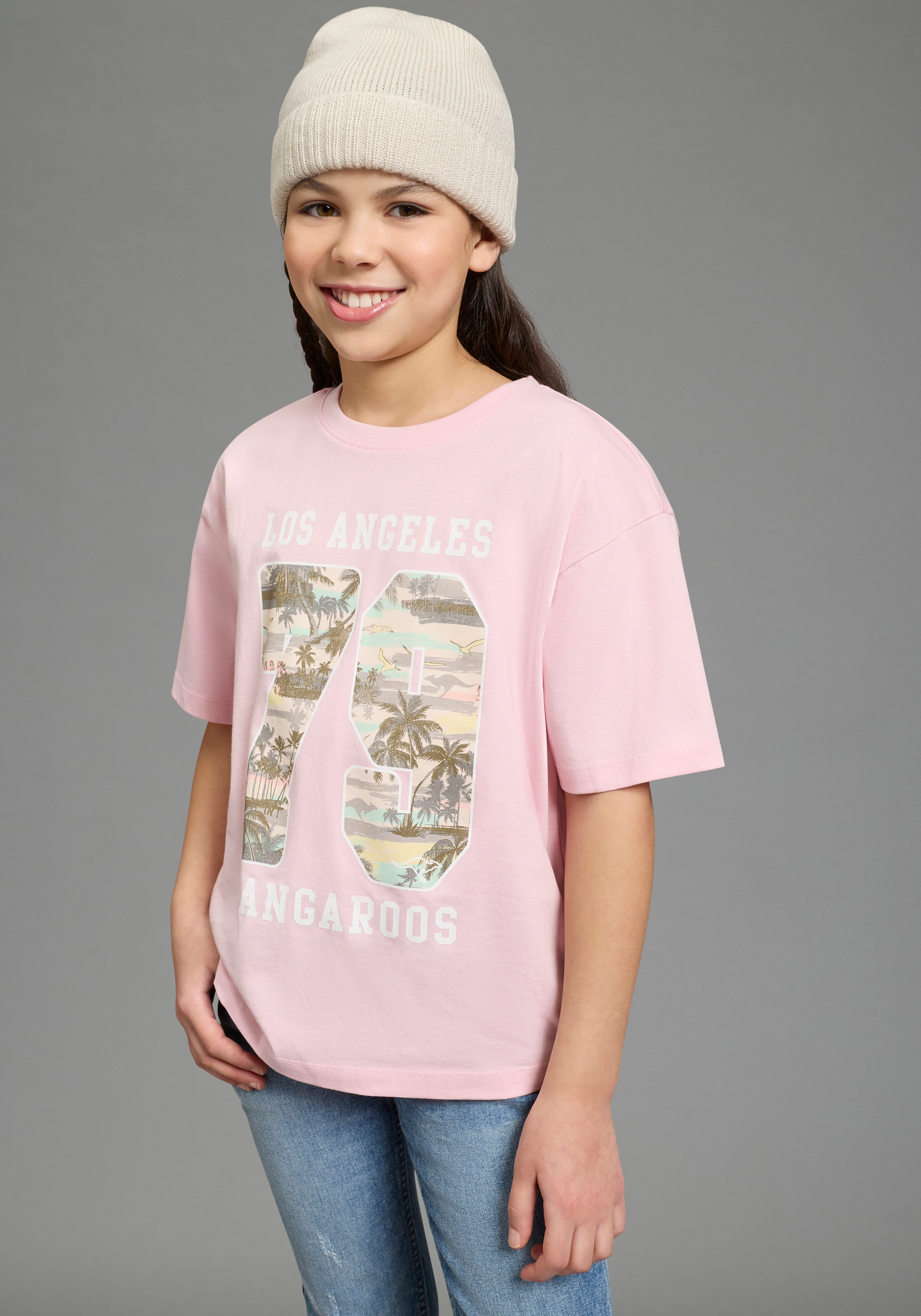 T-Shirt KANGAROOS "Locker geschnittenes Shirt mit Palmenprint", Mädchen, Gr. 152/158, rosa, Single Jersey, Obermaterial: 100% Baumwolle, bedruckt, lässig geschnitten, Rundhals, Shirts T-Shirt, lässige Passform, Kurzarm, bedruckt, aus Baumwolle