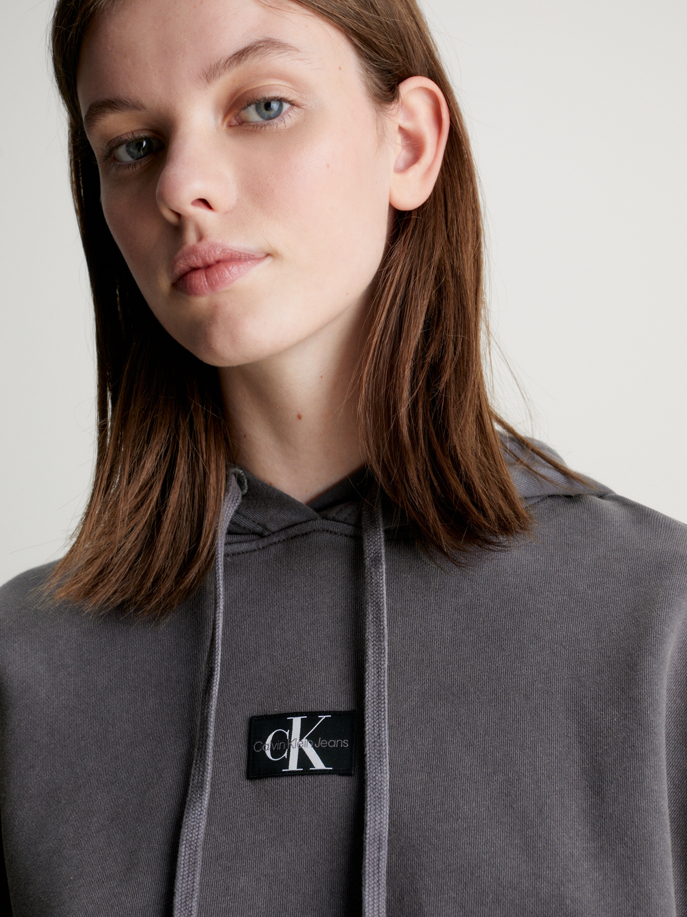 Calvin Klein Jeans Kapuzensweatshirt »WASHED WOVEN LABEL HOODIE«, mit Logoschriftzug

