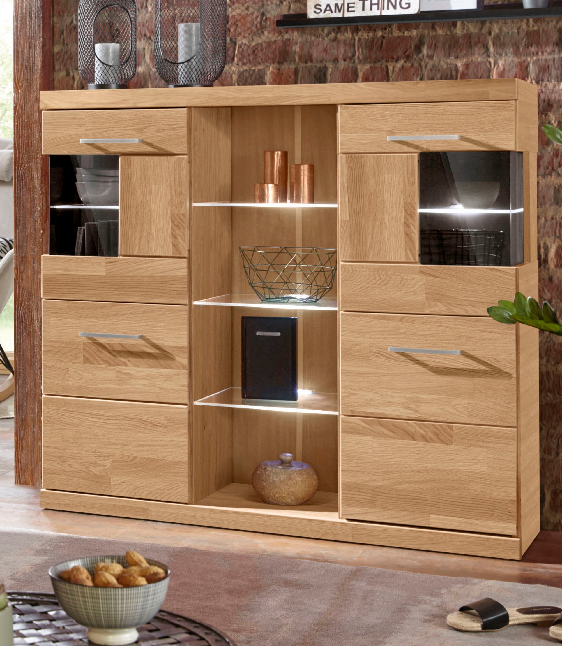 OTTO home Highboard "Ribe,120cm breit,112cm hoch,Oberplatte massiv,12 Fächer" Holz massiv, Holzwerkstoff, Metall Griffe,2Türen mit Glaseinsatz